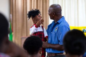 NEVILLE REMKISSOON DEMONSTRATES WITH A PUPPET HOW TEACHERS CAN ENGAGE CHILDREN WITH THE GOSPEL MESSAGE.